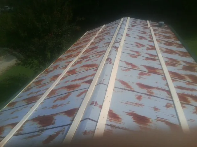 Rusted metal roof panels with new wood purlins before replacement — Storm Damage Roof Repair in Hughson by Roofing Brothers