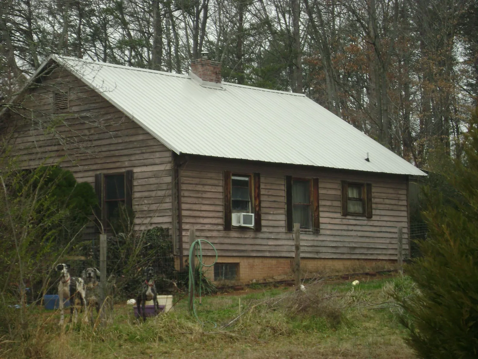White metal roof on an old wood sided farmhouse, from a Metal Roof Installation job in Hughson